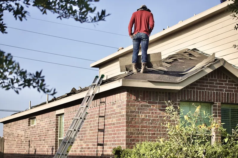 Professional roofer working on a residential roof in River Oaks